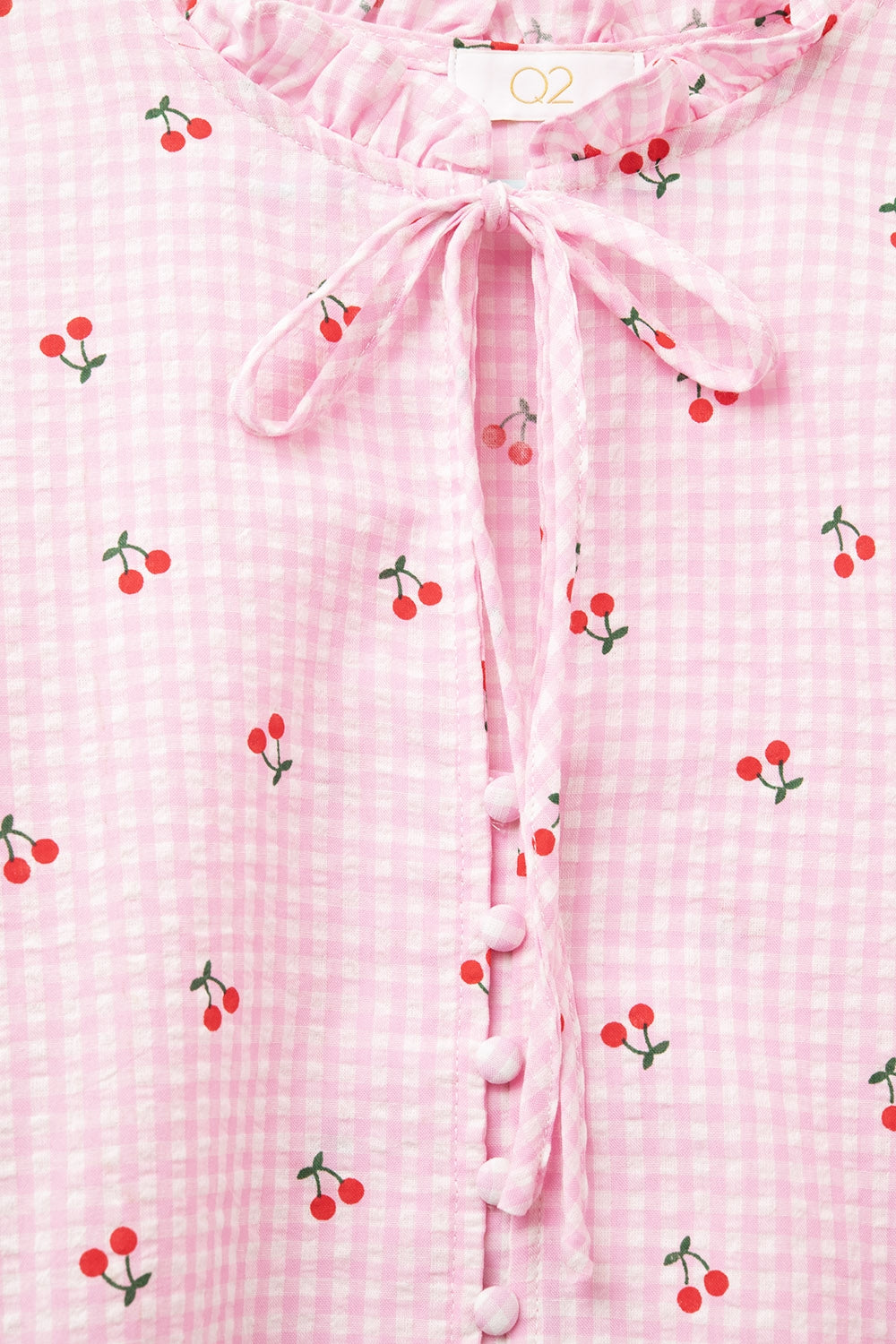 Blusa cor-de-rosa com pormenores de cerejas e laço atado