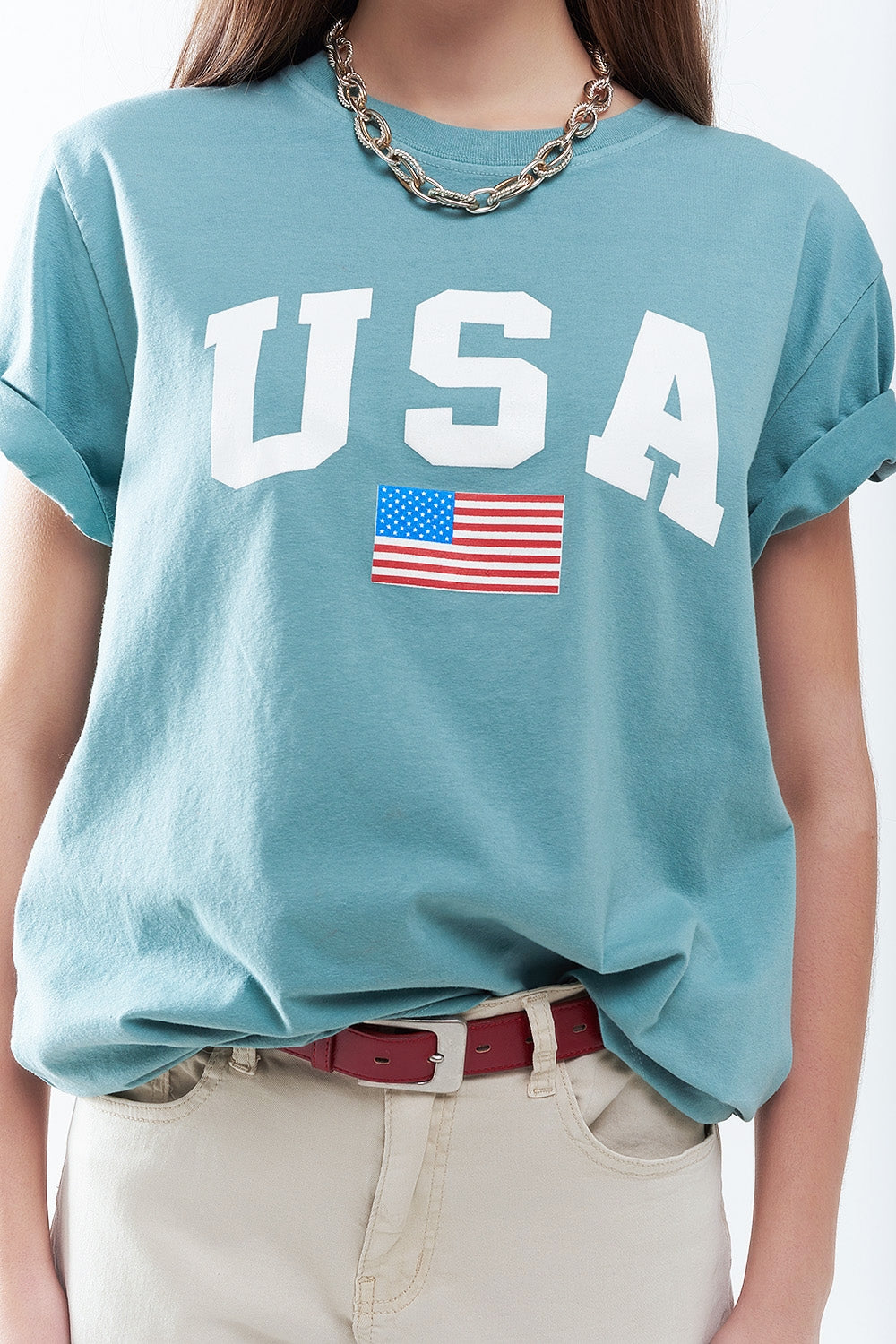 Camiseta longa solta verde com logotipo dos USA