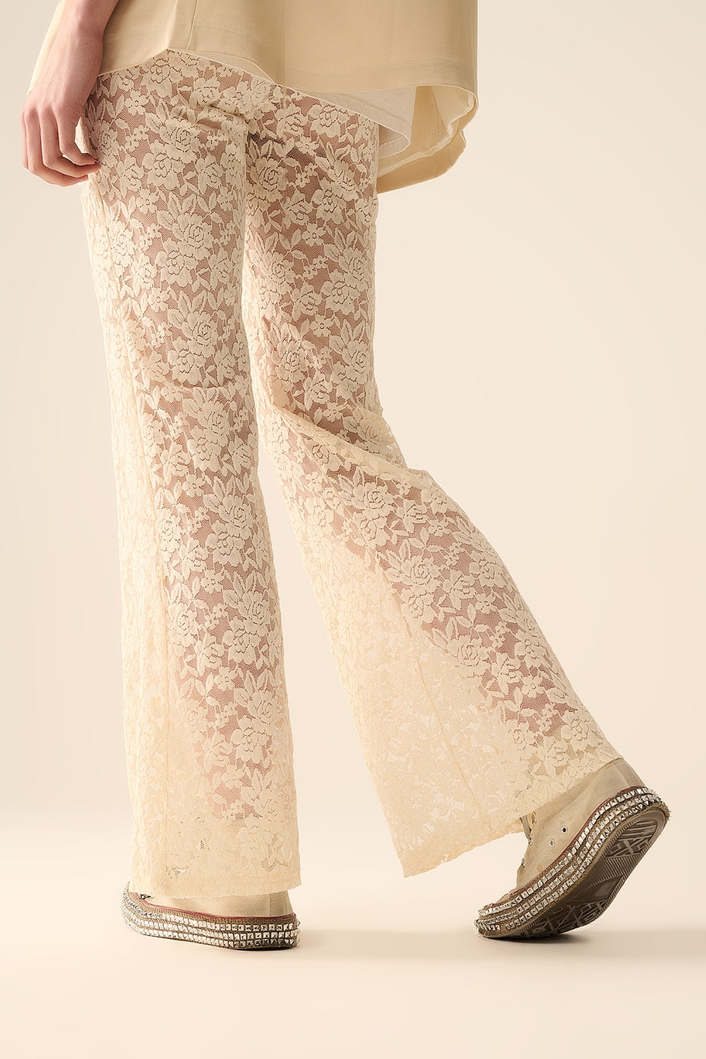 Calças flare de creme em renda floral