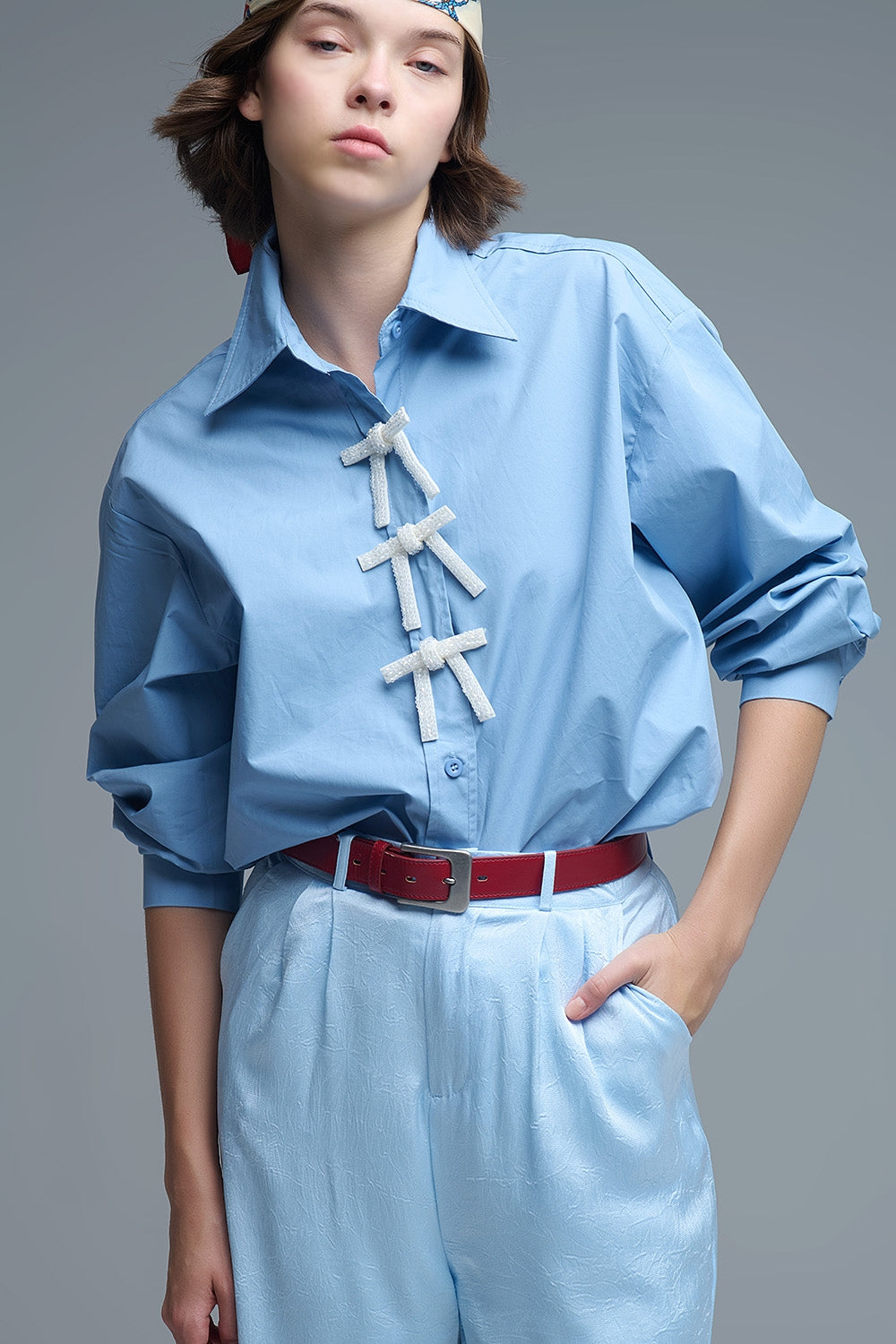 Camisa de popelina azul de tamanho grande com botões de laço brancos com brilhantes