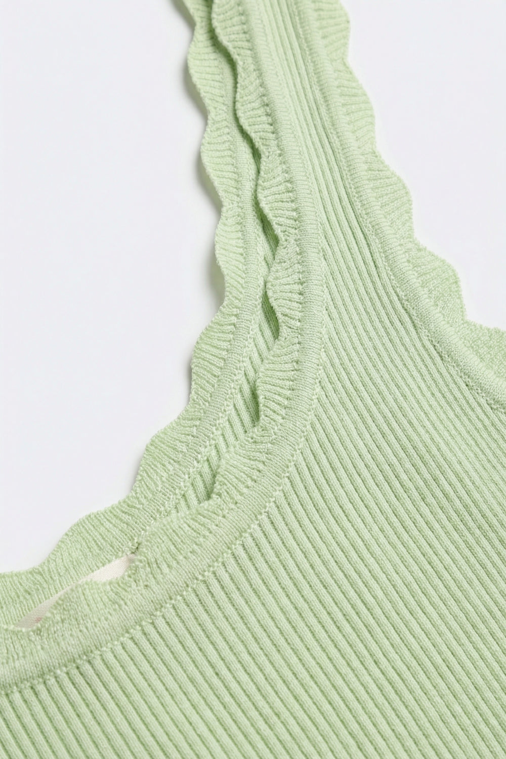 Camisola em malha canelada verde-clara com rebordos recortados