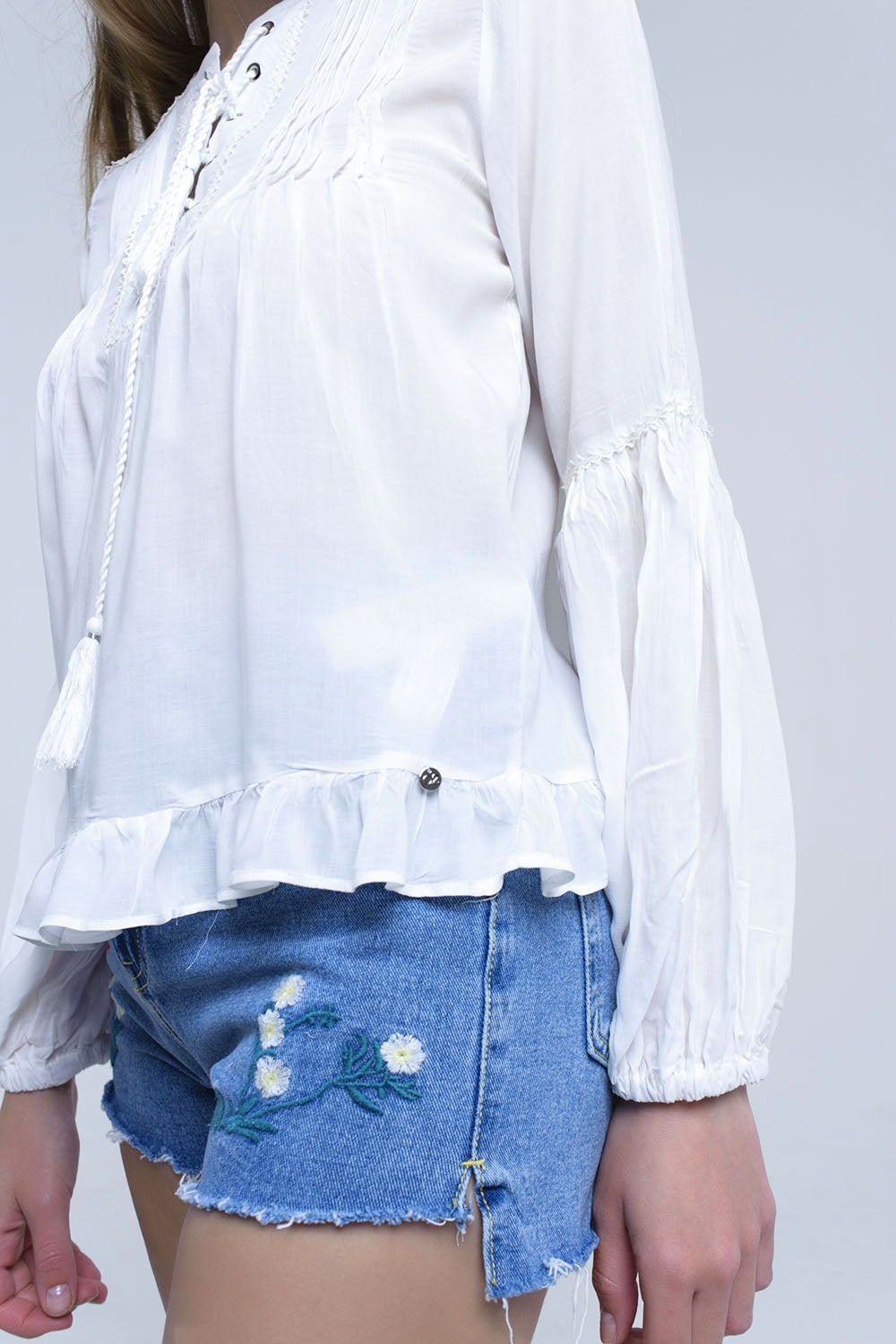 Top branco com detalhes atados e bainha com plissado