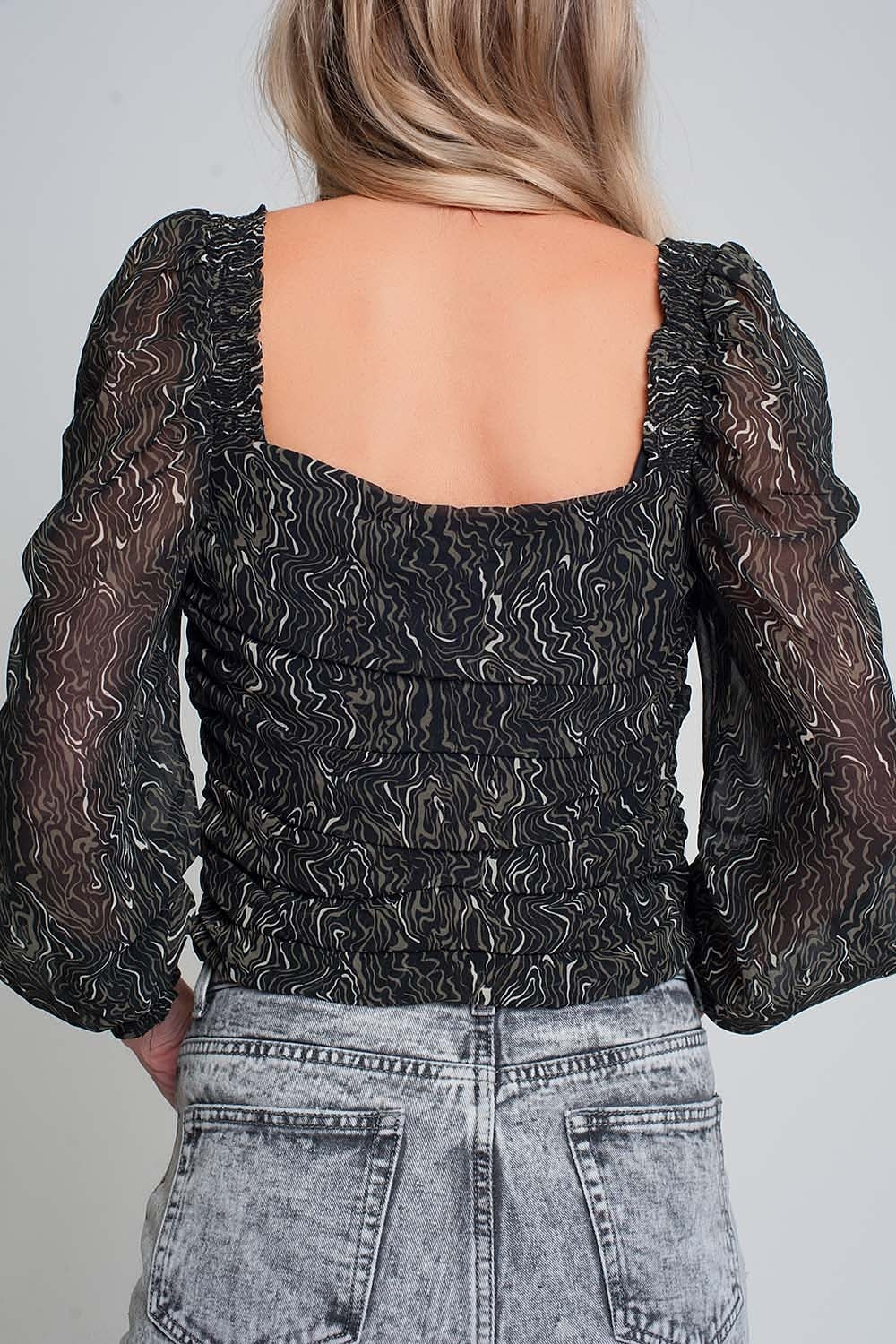 Blusa transparente de manga comprida estampada em preto com punhos elásticos