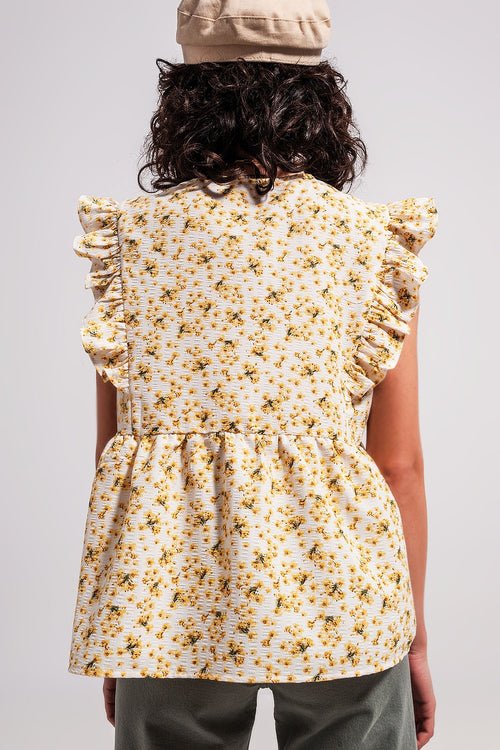 Blusa amarela com bordados e detalhes de rufos