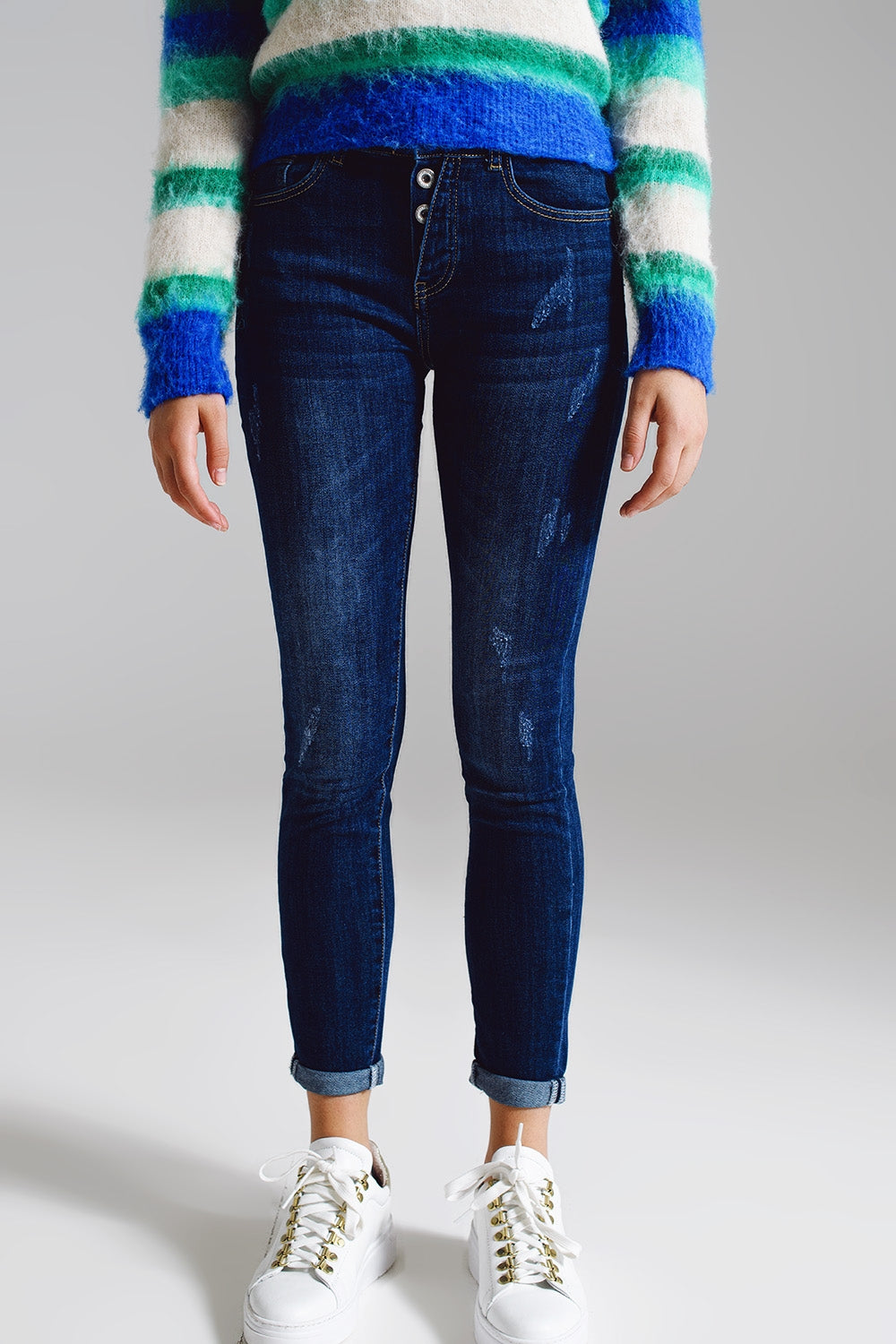 Jeans super skinny com botões frontais visíveis em azul médio