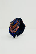 Diadema azul-marinho com detalhes em lantejoulas e strass.