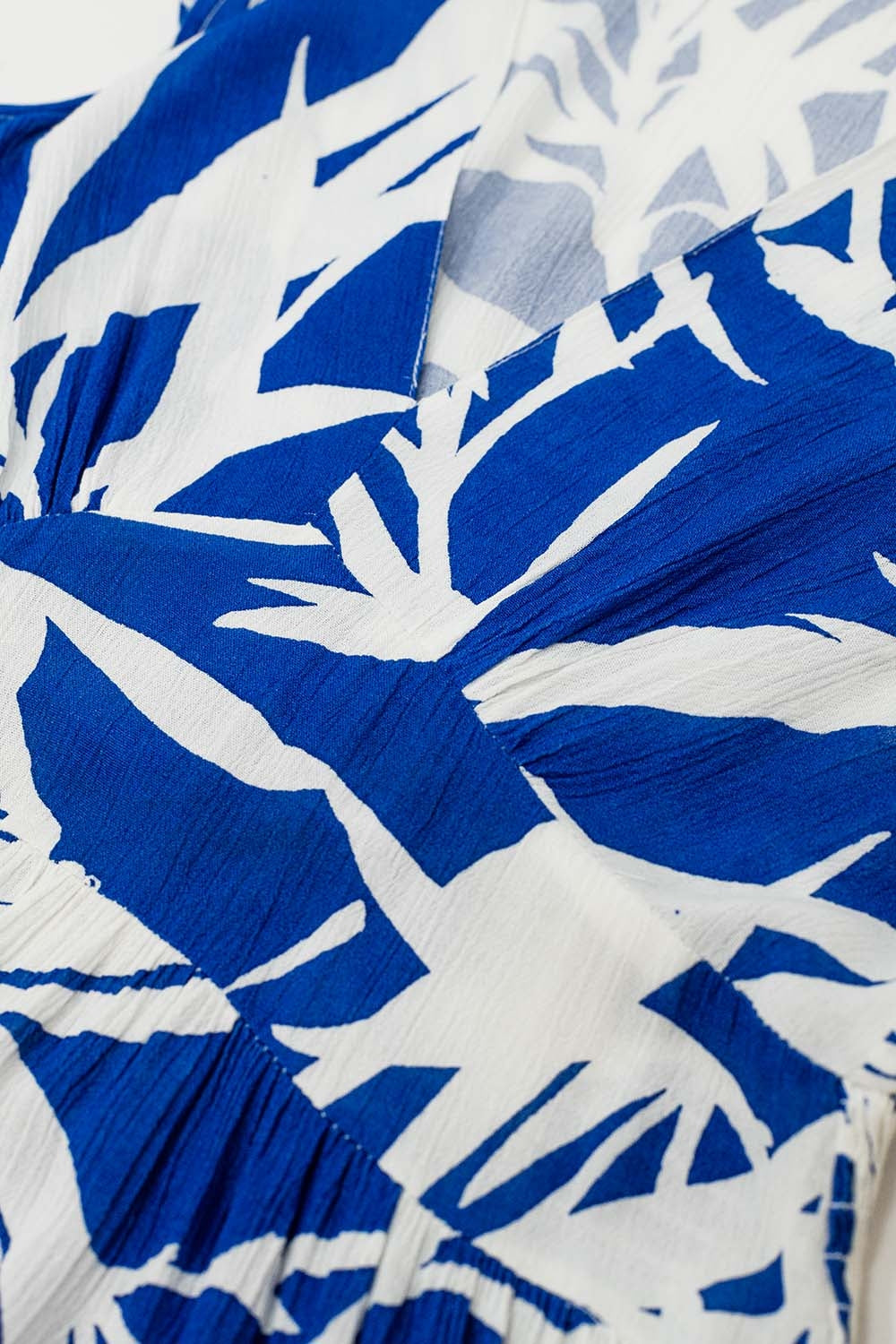 vestido curto azul com estampado de palmeiras tropicais